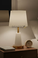 Modern metal table lamp with sleek finish designed for bedside lighting in contemporary bedrooms.